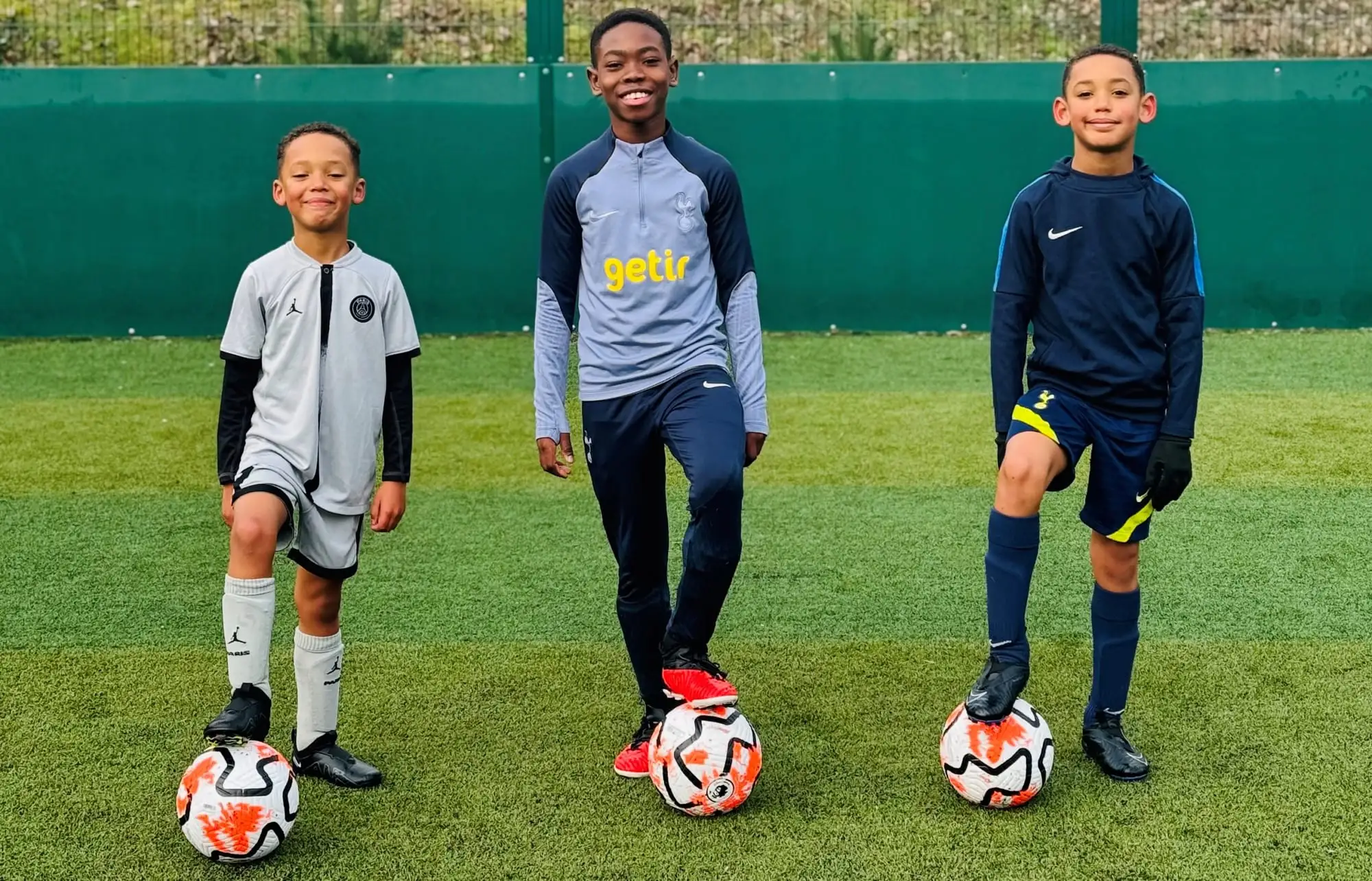A J-Stars coach with young players at the start of a session