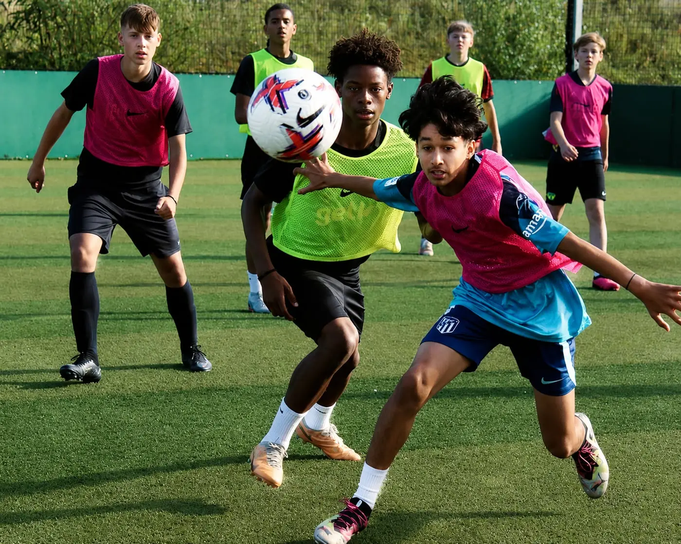 Players competing for a high ball at a J-Stars camp session